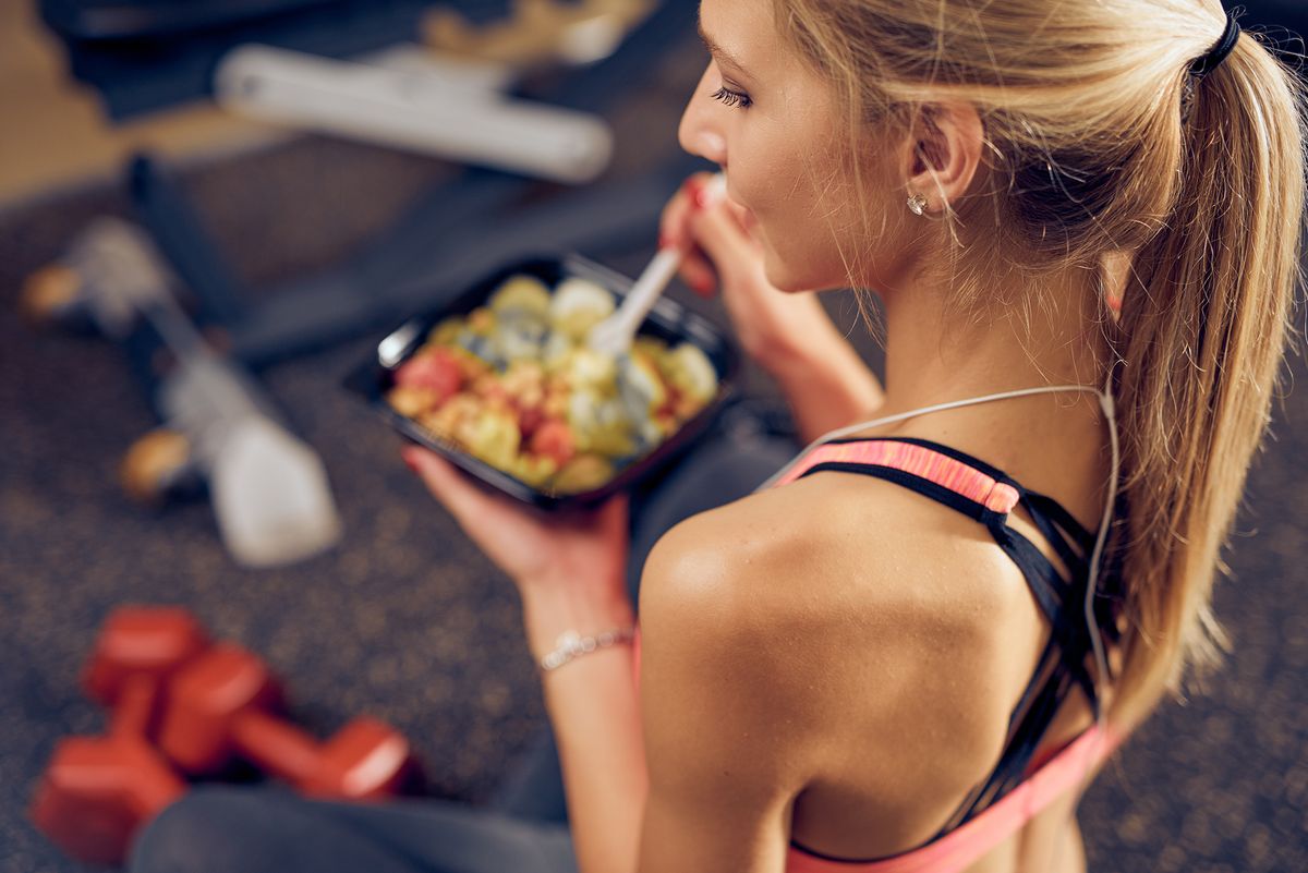 Top,View,Of,Woman,Eating,Healthy,Food,While,Sitting,In